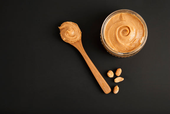 Peanuts and Fresh Peanut Butter Isoalted Black Background Protein Super Food Snack