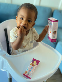 Baby MJ holding box of RSF! Blueberry Banana bars