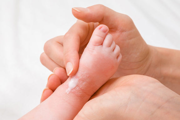 Baby's foot with moisturizer