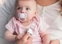 Closeup of baby with doctor and stethoscope - mobile view