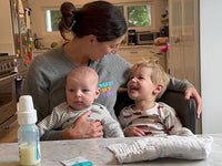 Mom with babies and a bottle of milk with RSF! Mix-ins inside