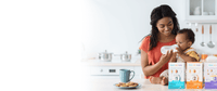 mom with child on kitchen counter and RSF boxes