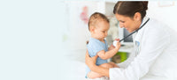 Baby plays with pediatrician's stethoscope