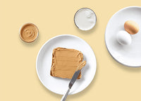 Overhead view of plates on a table with peanut butter and eggs - mobile view