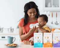 mom with child on kitchen counter and RSF boxes
